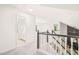 Hallway features wood railing, skylight, and access to a bathroom for convenient living at 304 W Kirkfield Dr, Cary, NC 27518