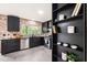 Well-lit kitchen showcasing dark cabinetry, stainless steel appliances, and a brick backsplash at 304 W Kirkfield Dr, Cary, NC 27518