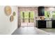 Bright kitchen featuring stainless steel appliances, a brick backsplash, and sliding doors to an outdoor deck at 304 W Kirkfield Dr, Cary, NC 27518