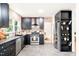 Modern kitchen with brick walls, black cabinets, and stainless steel appliances at 304 W Kirkfield Dr, Cary, NC 27518
