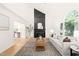 Bright living room with large window, sleek fireplace, and neutral color palette at 304 W Kirkfield Dr, Cary, NC 27518