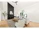 Spacious living area with tall fireplace, large window, and stylish furniture arrangement at 304 W Kirkfield Dr, Cary, NC 27518