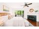 Bright main bedroom features a fireplace, hardwood floors, and access to the outdoor area at 304 W Kirkfield Dr, Cary, NC 27518