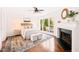 Serene main bedroom with a fireplace, plush rug, and large windows leading to an outdoor deck at 304 W Kirkfield Dr, Cary, NC 27518