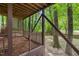 Under-deck area with lattice and wooded surroundings offers a unique outdoor space at 304 W Kirkfield Dr, Cary, NC 27518