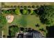 An aerial view shows a spacious yard with a fire pit and mature landscaping at 3128 Mountain Hill Dr, Wake Forest, NC 27587