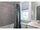 Bathroom featuring a tub, a gray shower curtain, tiled walls, and plenty of natural light at 3128 Mountain Hill Dr, Wake Forest, NC 27587