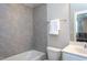 Bathroom featuring large gray tiling in shower and a white cabinet sink at 3128 Mountain Hill Dr, Wake Forest, NC 27587