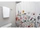 Charming bathroom detail featuring a floral shower curtain and a towel rack with plush white towels at 3128 Mountain Hill Dr, Wake Forest, NC 27587