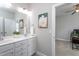 Bright bathroom with double vanity sinks, a large mirror, a modern faucet, and neutral paint at 3128 Mountain Hill Dr, Wake Forest, NC 27587