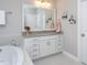 Bathroom featuring a large soaking tub and a modern white cabinet sink at 3128 Mountain Hill Dr, Wake Forest, NC 27587