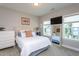 Cozy bedroom with natural light, a comfortable bed, a full-length mirror, and stylish decor at 3128 Mountain Hill Dr, Wake Forest, NC 27587