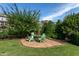 A stone patio with a central fire pit and seating offers a cozy outdoor space at 3128 Mountain Hill Dr, Wake Forest, NC 27587