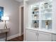 Hallway with built-in white cabinets and a decorative display shelf with various items at 3128 Mountain Hill Dr, Wake Forest, NC 27587