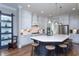 A modern kitchen features white cabinets, stainless steel appliances, and an island with a white countertop at 3128 Mountain Hill Dr, Wake Forest, NC 27587