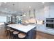 Bright kitchen with island seating, stainless steel appliances and streamlined white cabinets at 3128 Mountain Hill Dr, Wake Forest, NC 27587