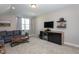 Comfortable living room with large gray couch, TV, mini-fridge, and stylish decor at 3128 Mountain Hill Dr, Wake Forest, NC 27587