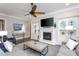 Comfortable living room with a fireplace, built-in shelving, and large windows at 3128 Mountain Hill Dr, Wake Forest, NC 27587