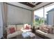 Inviting screened porch with comfortable wicker furniture and curtains at 3128 Mountain Hill Dr, Wake Forest, NC 27587