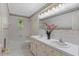 Bright bathroom with double sinks, floral wallpaper, and tiled floors at 3329 Broughton Dr, Durham, NC 27704
