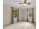 Bedroom with neutral walls, carpet flooring, and two windows with wooded views at 3329 Broughton Dr, Durham, NC 27704