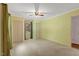 Neutral-toned bedroom featuring carpet floors, ceiling fan, and windows at 3329 Broughton Dr, Durham, NC 27704