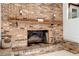 Close-up of the brick fireplace featuring a wooden mantle and brick hearth at 3329 Broughton Dr, Durham, NC 27704