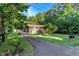 Inviting brick home with a well-maintained lawn, mature trees, and curb appeal at 3329 Broughton Dr, Durham, NC 27704