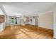 Spacious living room with hardwood floors, and white cabinetry for a bright and airy feel at 3329 Broughton Dr, Durham, NC 27704