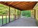 Enjoy the outdoors from this screened-in porch with wood ceiling and a view of the lush lawn at 3329 Broughton Dr, Durham, NC 27704