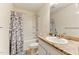 Well-lit bathroom featuring a vanity with a granite countertop and a shower-tub combo at 350 Pillow Ln, Burlington, NC 27217