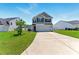 Charming two-story home with a well-manicured lawn and a spacious driveway on a sunny day at 350 Pillow Ln, Burlington, NC 27217