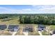 Aerial of homes reveals a desirable location near green spaces, a pond, and the surrounding wooded areas at 351 Lowery Ln, Benson, NC 27504