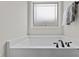 Relaxing bathtub with elegant fixtures and a window view at 351 Lowery Ln, Benson, NC 27504