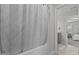 Bathroom with a textured shower curtain and an open doorway to a bedroom beyond at 351 Lowery Ln, Benson, NC 27504