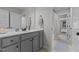 Bathroom features a single sink vanity with grey cabinetry and a large mirror at 351 Lowery Ln, Benson, NC 27504