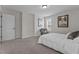 Cozy bedroom featuring carpet floors, large window, and queen bed at 351 Lowery Ln, Benson, NC 27504