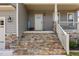 Inviting front porch steps with stone accents and manicured landscaping that leads to the front door at 351 Lowery Ln, Benson, NC 27504