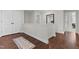 Hallway with wood floors, white trim, doors and a decorative rug at 351 Lowery Ln, Benson, NC 27504