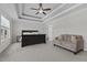 Main bedroom with tray ceiling, neutral carpet, and seating area at 351 Lowery Ln, Benson, NC 27504