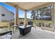 Covered patio with wicker furniture, curtains and view to backyard at 351 Lowery Ln, Benson, NC 27504
