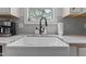 Close up on white undermount kitchen sink with granite countertops and modern fixtures at 351 Lowery Ln, Benson, NC 27504