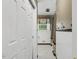 Narrow, retro bathroom featuring white tile, floral patterned window and curtain at 418 S West St, Cary, NC 27511