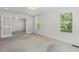 Large bedroom with neutral carpet, windows and French doors at 418 S West St, Cary, NC 27511