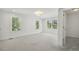 Bright bedroom with neutral carpet, three windows and an ensuite bath at 418 S West St, Cary, NC 27511