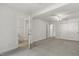 Spacious bedroom showcasing neutral carpet, fresh white walls, a ceiling fan, and an attached bathroom at 418 S West St, Cary, NC 27511