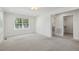 Bright bedroom with neutral carpet, an ensuite bath and a walk-in closet at 418 S West St, Cary, NC 27511