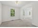 Neutral bedroom featuring two large windows and glass paneled French doors at 418 S West St, Cary, NC 27511