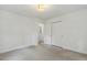 Spacious bedroom showcasing neutral carpet, fresh white walls, closet, and a classic ceiling light fixture at 418 S West St, Cary, NC 27511
