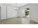 Bright dining area features tile flooring, modern lighting, and sliding doors to an outdoor space at 418 S West St, Cary, NC 27511